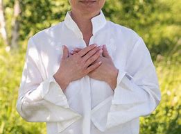 Woman with hands over heart. Heart Connection Pose