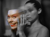 Sad woman removing her happy face.